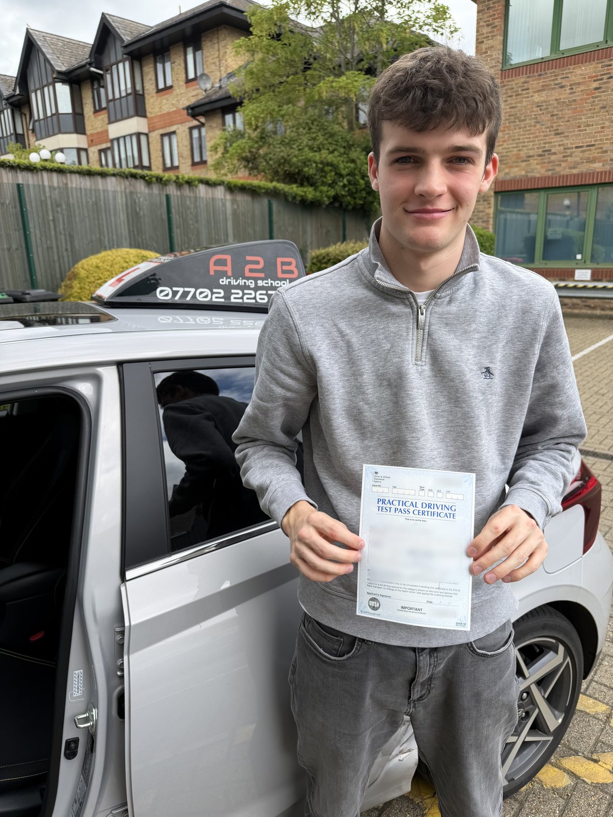 A2B student holding their driving test pass certificate