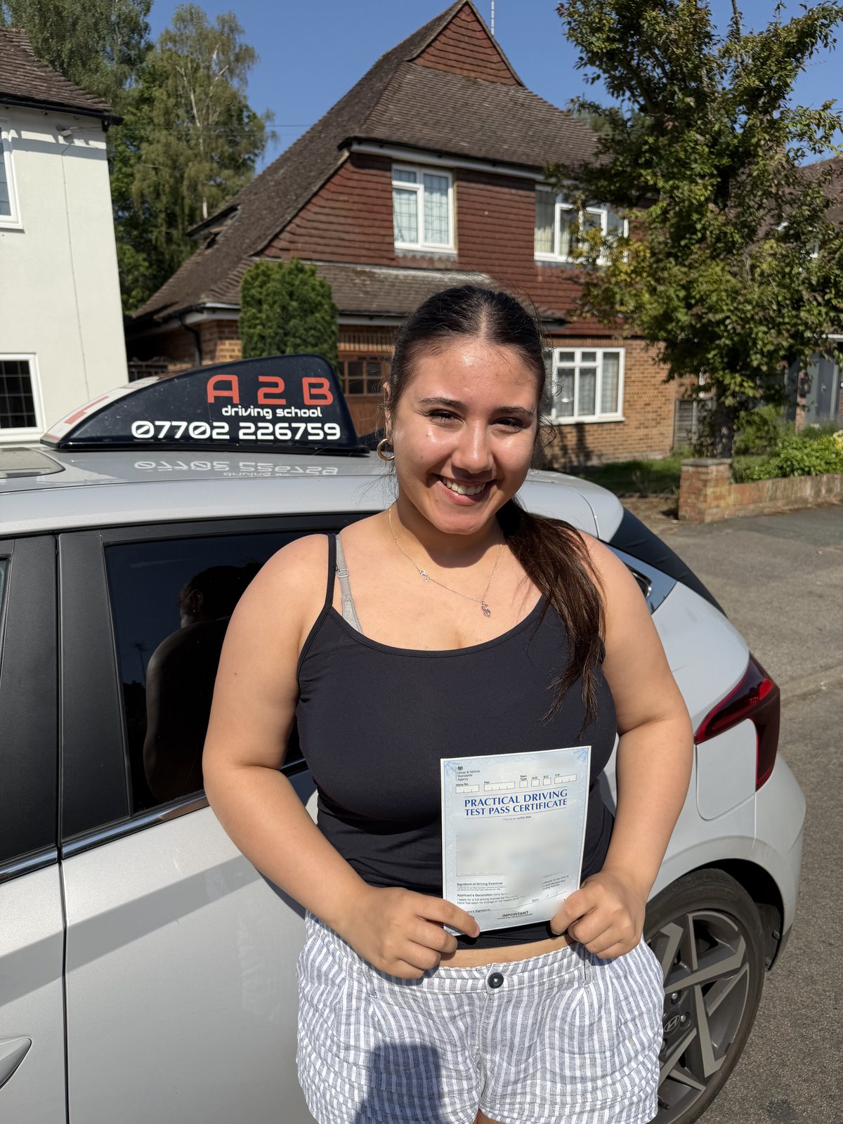 A2B student holding their driving test pass certificate